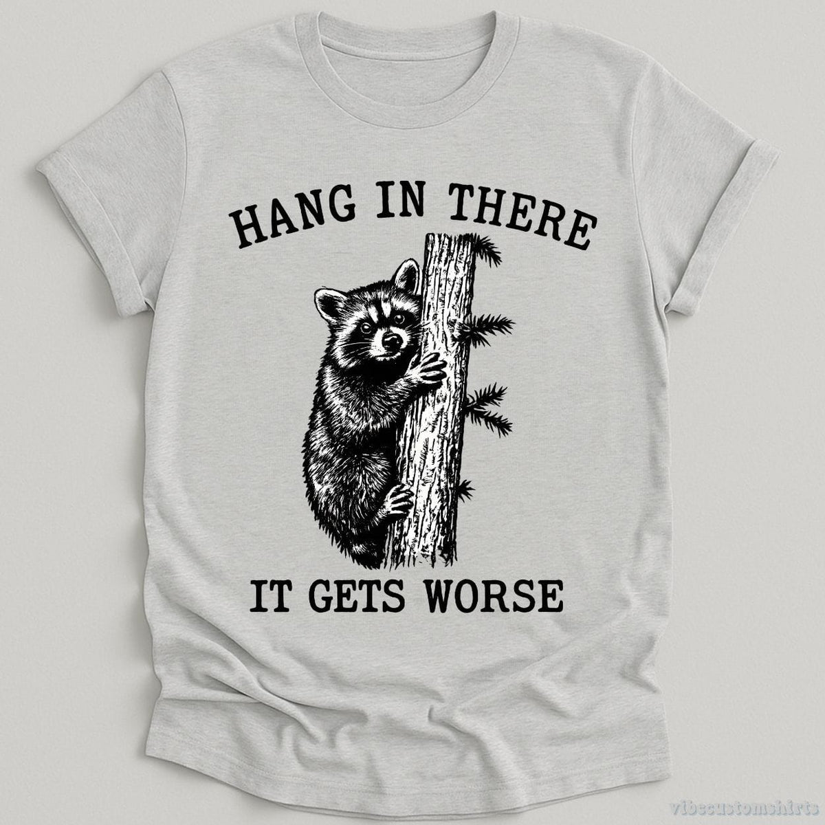 Hang in There It Gets Worse Raccoon T-shirt graphic design — view 1